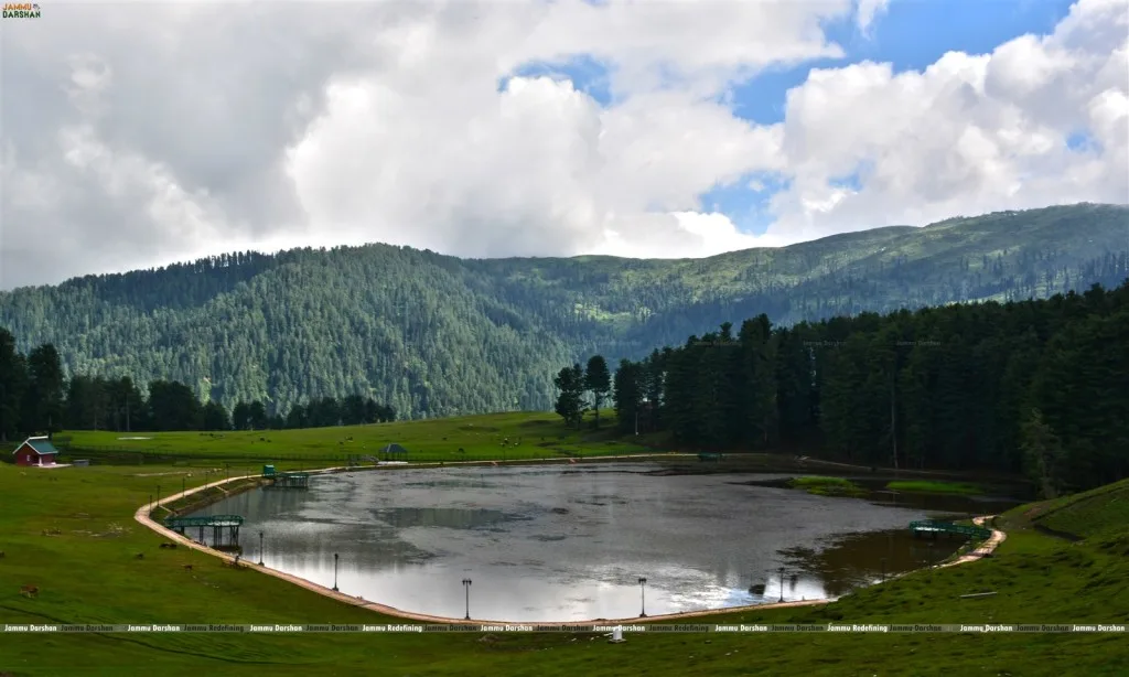 Sanasar Lake with paddle boats in the meadow bowl, Ramban